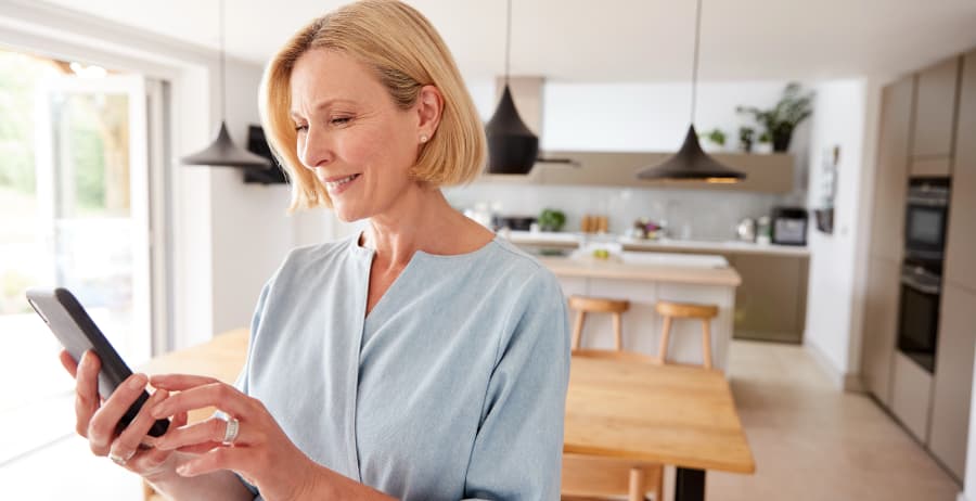 Woman using a smartphone in a stylish home